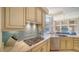 Gourmet kitchen featuring gas cooktop, stone countertops, stainless appliances and beautiful blue tile backsplash at 3521 Fair Oaks Ln, Longboat Key, FL 34228