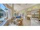 Open floor plan with a breakfast nook, chandelier, and large windows with views of the pool at 3521 Fair Oaks Ln, Longboat Key, FL 34228