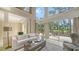 Bright living room features high ceilings, a large window with backyard views, and neutral decor at 3521 Fair Oaks Ln, Longboat Key, FL 34228