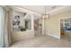 Bright living room features high ceilings, a large window with backyard views, and neutral decor at 3521 Fair Oaks Ln, Longboat Key, FL 34228