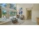 Bright living room features high ceilings, a large window with backyard views, and neutral decor at 3521 Fair Oaks Ln, Longboat Key, FL 34228