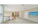 Open loft with carpet, railing, and large windows to let in natural light at 3521 Fair Oaks Ln, Longboat Key, FL 34228