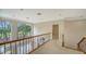 Hallway with railing overlooking the entry and large windows providing natural light and neighborhood views at 3521 Fair Oaks Ln, Longboat Key, FL 34228
