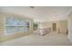 Spacious loft area with neutral carpet, large windows, and railing overlooking the entry at 3521 Fair Oaks Ln, Longboat Key, FL 34228