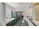 Elegant bathroom featuring a soaking tub, a glass-enclosed shower, and double sinks with vanity space at 3521 Fair Oaks Ln, Longboat Key, FL 34228