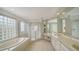 Bright bathroom featuring a large vanity, glass shower, and luxurious soaking tub for ultimate relaxation at 3521 Fair Oaks Ln, Longboat Key, FL 34228