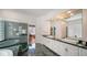 Luxurious main bathroom with a stylish glass enclosed shower, elegant tub, dual sinks, and rich marble finishes at 3521 Fair Oaks Ln, Longboat Key, FL 34228