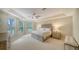 Inviting main bedroom with tray ceiling, fan, and ample natural light showcasing the comfort of the home at 3521 Fair Oaks Ln, Longboat Key, FL 34228