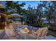Relaxing outdoor space with comfortable seating around a cozy fire pit, surrounded by lush greenery at 3521 Fair Oaks Ln, Longboat Key, FL 34228