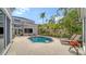 Private pool with a spacious brick patio, surrounded by tropical landscaping, perfect for relaxation at 3521 Fair Oaks Ln, Longboat Key, FL 34228