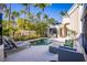 Inviting pool and lounge area surrounded by lush tropical landscaping, perfect for relaxation and privacy at 3521 Fair Oaks Ln, Longboat Key, FL 34228