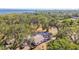 Scenic aerial view of home surrounded by lush greenery, with a water view in the background at 3619 Elm St, Ellenton, FL 34222