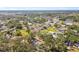 An aerial perspective showcasing a neighborhood with lush trees, manicured lawns, and access to nearby shops at 3619 Elm St, Ellenton, FL 34222