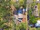 Overhead view of the home and its surroundings, featuring a large lot, mature trees, and landscaping at 3619 Elm St, Ellenton, FL 34222
