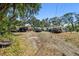 View of property featuring mature trees, shed, a truck, and a trailer at 3619 Elm St, Ellenton, FL 34222