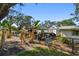 View of property featuring shed, mature trees and foliage in the backyard at 3619 Elm St, Ellenton, FL 34222