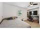 Bedroom with neutral paint, ceiling fan and closet/office nook featuring floating shelves and desk space at 3619 Elm St, Ellenton, FL 34222