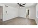 Neutral bedroom with hardwood floors, ceiling fan, and an ensuite bathroom at 3619 Elm St, Ellenton, FL 34222
