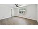 Bedroom with neutral paint and light wood-look tile flooring, with a large picture window at 3619 Elm St, Ellenton, FL 34222