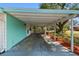 This image shows the carport of the property with mature trees at 3619 Elm St, Ellenton, FL 34222