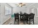 Bright dining area features wood-look tile flooring and a ceiling fan at 3619 Elm St, Ellenton, FL 34222