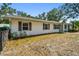 View of a single-story house with white siding, situated in a landscaped front yard at 3619 Elm St, Ellenton, FL 34222