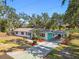 Charming single-story home with a carport, well-maintained yard, and mature trees at 3619 Elm St, Ellenton, FL 34222
