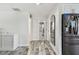 Hallway with wood-look tile flooring leads to a full bathroom, adding modern style at 3619 Elm St, Ellenton, FL 34222