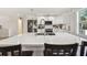 Bright kitchen with white cabinets, wood-look tile flooring, and stainless steel appliances at 3619 Elm St, Ellenton, FL 34222