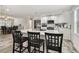 Open kitchen with white cabinets, stainless steel appliances and breakfast bar area at 3619 Elm St, Ellenton, FL 34222