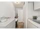Laundry room with white cabinets and appliances and a door that leads outside at 3619 Elm St, Ellenton, FL 34222