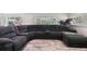 Bright living room with expansive sectional sofa and natural light from surrounding windows at 3619 Elm St, Ellenton, FL 34222