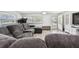 Bright living room with a comfortable sectional sofa, exercise bike, and wood-look tile flooring at 3619 Elm St, Ellenton, FL 34222