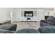 Open concept living room with large television and comfortable seating area at 3619 Elm St, Ellenton, FL 34222