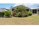 Landscaped backyard with mature bougainvillea bush and well-maintained lawn at 3662 Bonaventure Ct, Sarasota, FL 34243