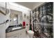 Well-lit bathroom with a black marble sink, modern fixtures, and a unique, eye-catching shower curtain at 3662 Bonaventure Ct, Sarasota, FL 34243