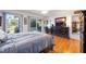 Cozy bedroom with wood flooring, a large dresser, a ceiling fan, and a sliding glass door at 3662 Bonaventure Ct, Sarasota, FL 34243
