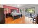 Spacious bedroom with hardwood floors, stylish decor, and sliding glass doors to the backyard patio at 3662 Bonaventure Ct, Sarasota, FL 34243