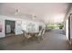 Spacious common room with tables, chairs, ceiling fans, and large windows at 3662 Bonaventure Ct, Sarasota, FL 34243