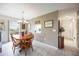 Bright dining room with wood table, chandelier and view into the kitchen at 3662 Bonaventure Ct, Sarasota, FL 34243