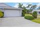 Spacious two-car garage with a large concrete driveway and manicured lawn at 3662 Bonaventure Ct, Sarasota, FL 34243