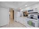 Bright kitchen with white cabinets, granite countertops, tile floors, and stainless-steel appliances at 3662 Bonaventure Ct, Sarasota, FL 34243