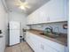 Kitchenette with white cabinets, sink, and appliances at 3662 Bonaventure Ct, Sarasota, FL 34243