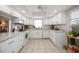 Well-lit kitchen with white cabinets, modern appliances, and ample counter space at 3662 Bonaventure Ct, Sarasota, FL 34243