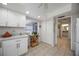 Bright kitchen with white cabinets, granite countertops, tile floors, and a wooden shelving unit at 3662 Bonaventure Ct, Sarasota, FL 34243