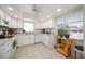 Bright eat-in kitchen with tile floors, white cabinets, granite countertops, and stainless-steel appliances at 3662 Bonaventure Ct, Sarasota, FL 34243