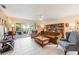Cozy living room with tile floors, bookshelves, ceiling fan and sliding door to the outside at 3662 Bonaventure Ct, Sarasota, FL 34243