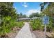 Paver path leading to villa and community facilities; Villas of Cedar Creek sign visible at 3662 Bonaventure Ct, Sarasota, FL 34243