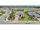 Stunning aerial view of a modern home featuring lush landscaping, a brick driveway, and close proximity to a community park at 3679 Santa Caterina Blvd, Bradenton, FL 34211
