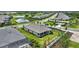 Aerial view displays a home with landscaping located near a golf course, highlighting its access to community amenities at 3679 Santa Caterina Blvd, Bradenton, FL 34211
